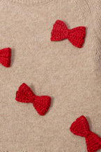  Detail van de rode strikjes op de beige Dr. Kid kindertrui